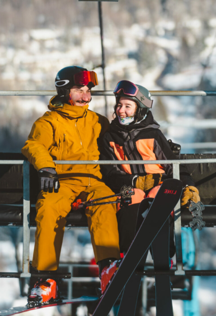 A lively winter sports scene at Ski Chantecler in Quebec Canada with a family enjoying skiing a child learning to ski and a ski lift seen in the background.