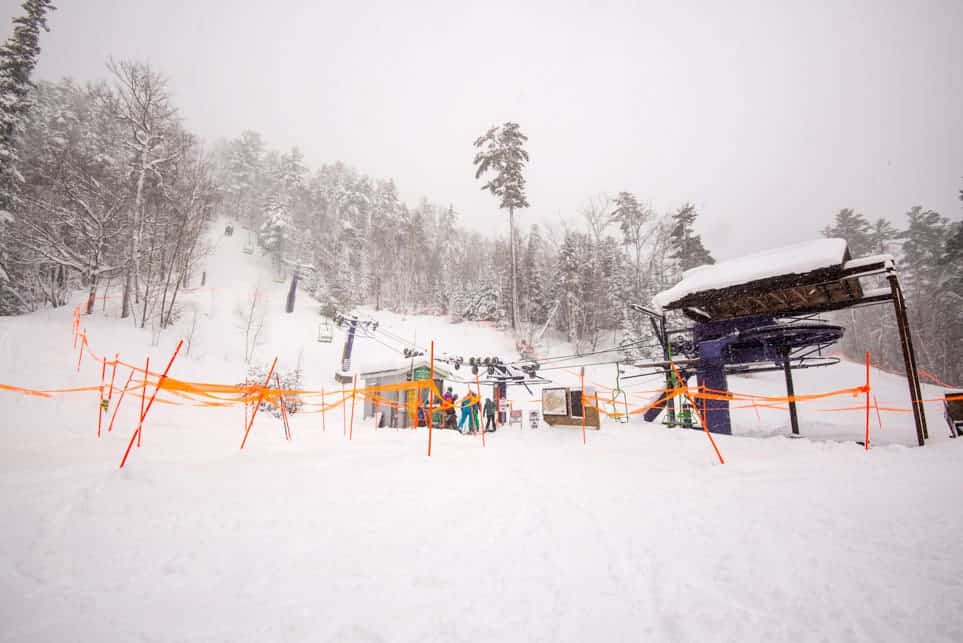 Enjoying winter sports at Mt. Bohemia a ski resort in Mohawk Michigan featuring a captivating winter landscape and a ski lift in operation.