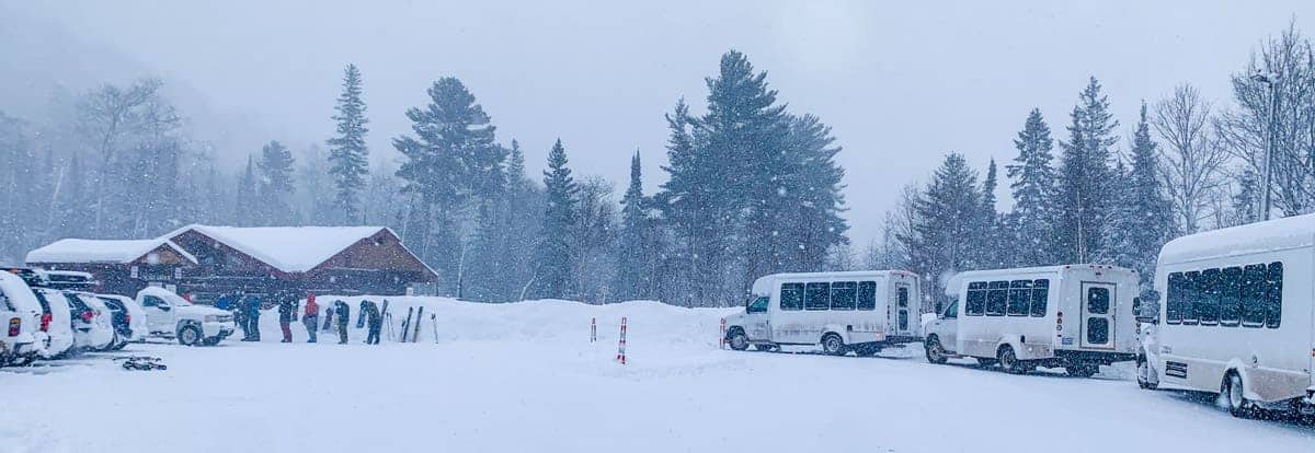 Mt Bohemia in USA - a group of buses parked on a snowy road.