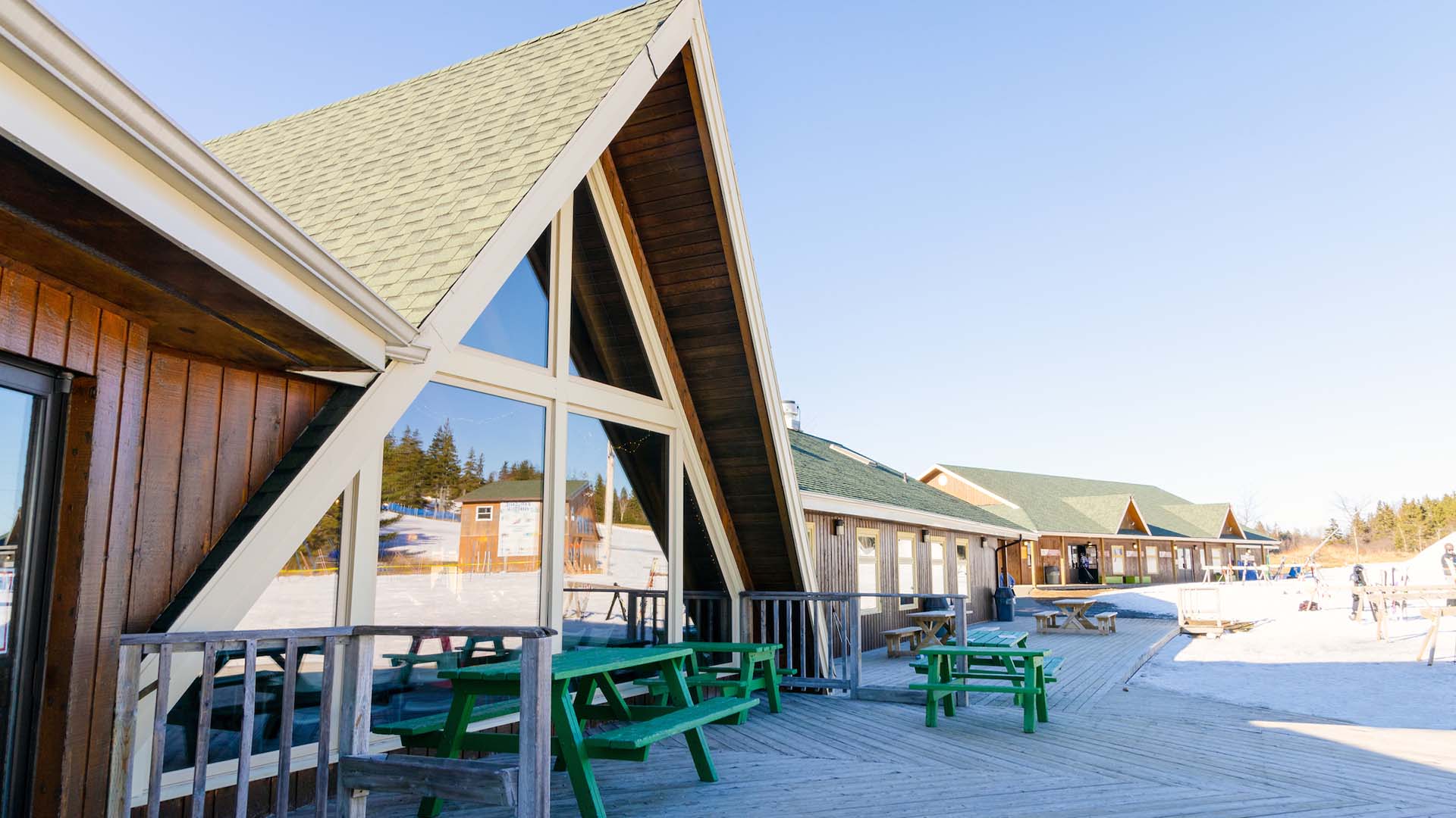 Winter sports centre with a lodge at Ben Eoin, Nova Scotia, Canada surrounded by snow, embodying the atmosphere of an active ski resort with an undisturbed winter landscape.
