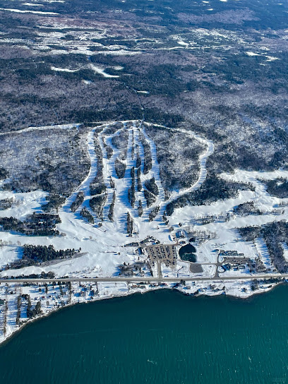 A picturesque view of Ben Eoin ski resort in Nova Scotia Canada featuring snow-covered slopes a ski lift and a thriving winter sports scene.