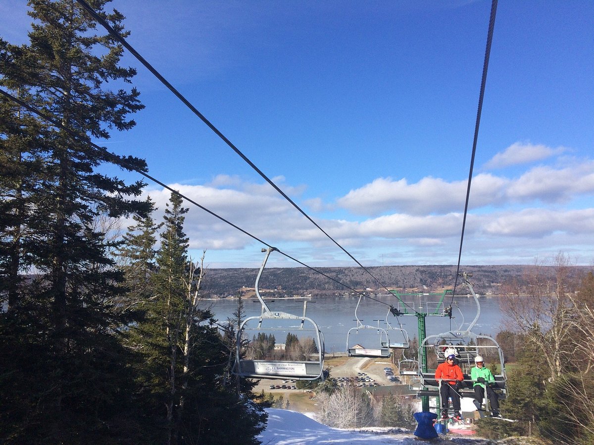 Ben Eoin in Canada - two people on a ski lift in the snow.