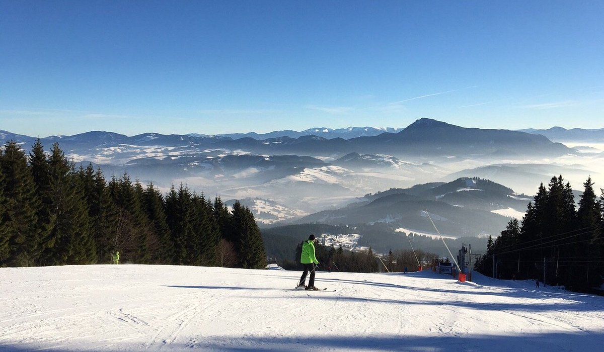 Kubínska hoľa in Slovakia - a person standing on top of a snow covered slope.