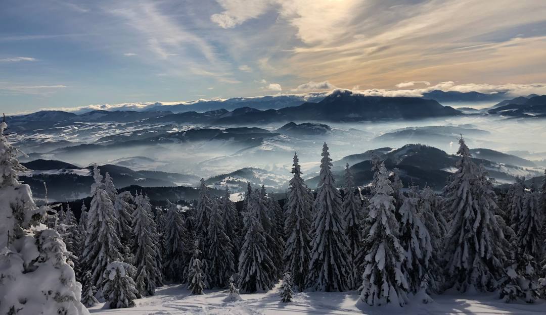 A picturesque view of Kubínska hoľa a popular ski resort in Slovakia showcasing a bustling winter sports scene against a stunning backdrop of snow-covered mountains and scenic winter beauty.