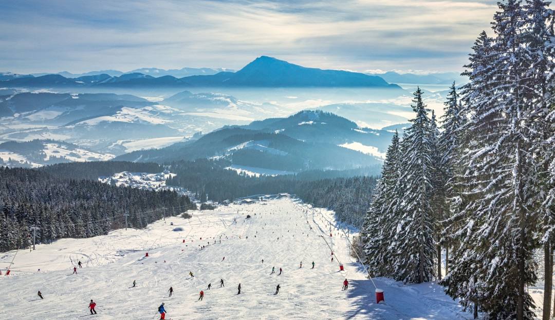 Winter sports scene at Kubínska hoľa ski resort in Slovakia, showcasing a stunning, snow-covered landscape with pristine ski slopes available for winter enthusiasts.