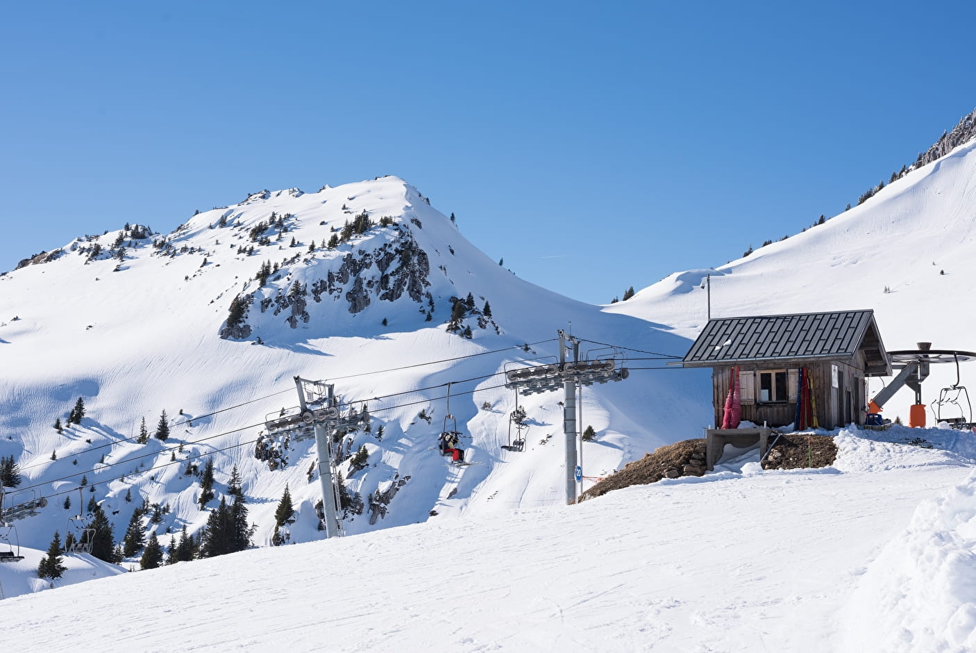 Scenic snow-covered landscape at Chapelle d'Abondance ski resort in France, prominently featuring a mountain chalet and ski lift.