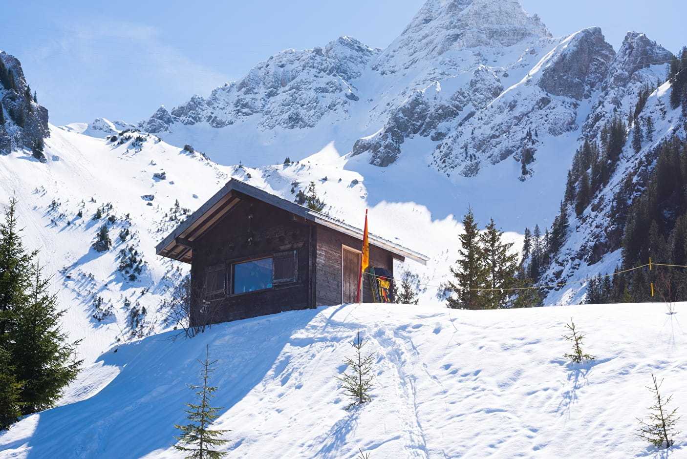 Winter scene at Chapelle d'Abondance in France, featuring a mountain hut, with hints of nearby ski resort activities.