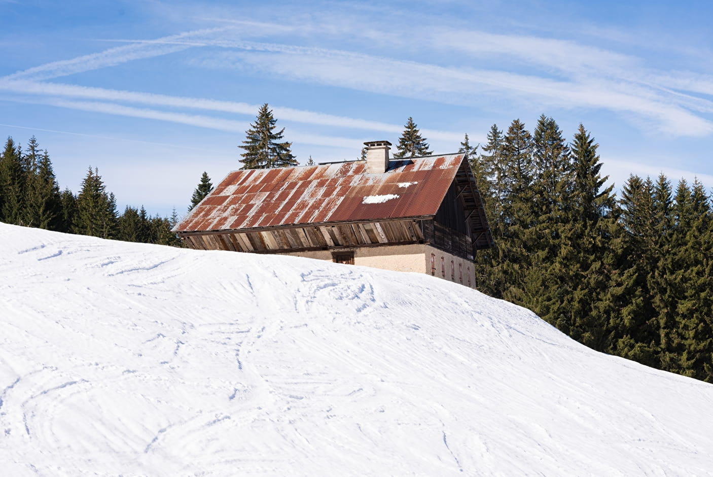 Winter sports enthusiasts enjoying a picturesque day at the Chapelle d'Abondance ski resort in France, with quaint mountain huts and chalets nearby.