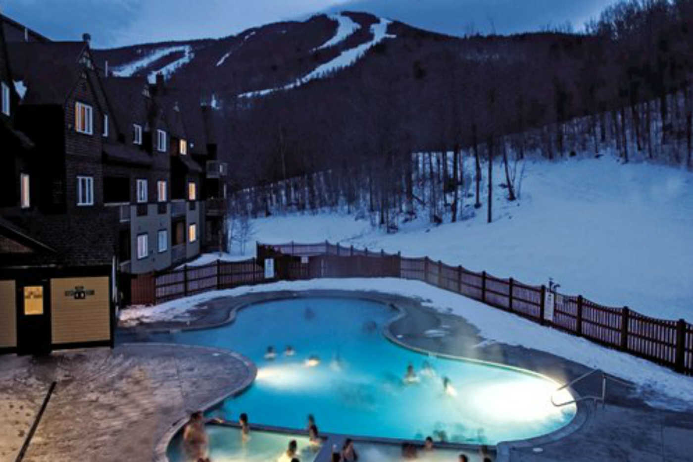 Sunday River in USA - an outdoor pool surrounded by snow at night.