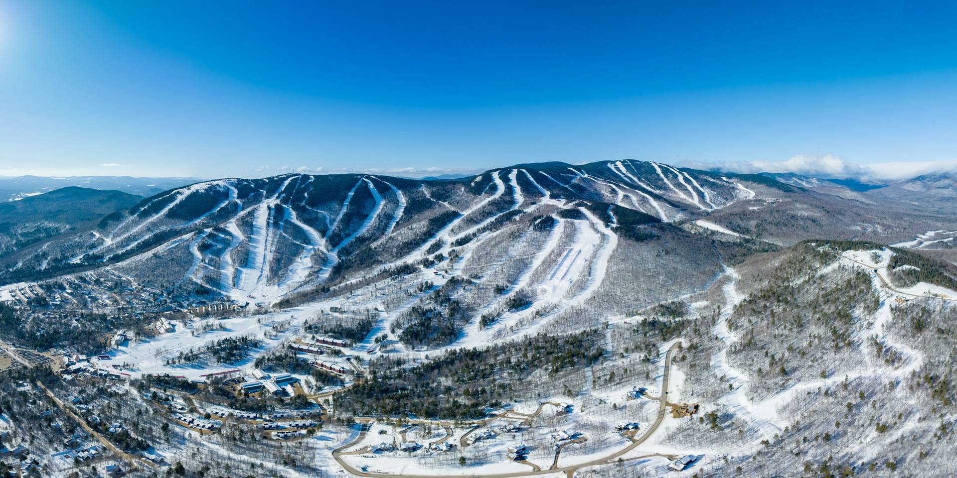 Sunday River in USA: a ski resort surrounded by snow covered mountains.