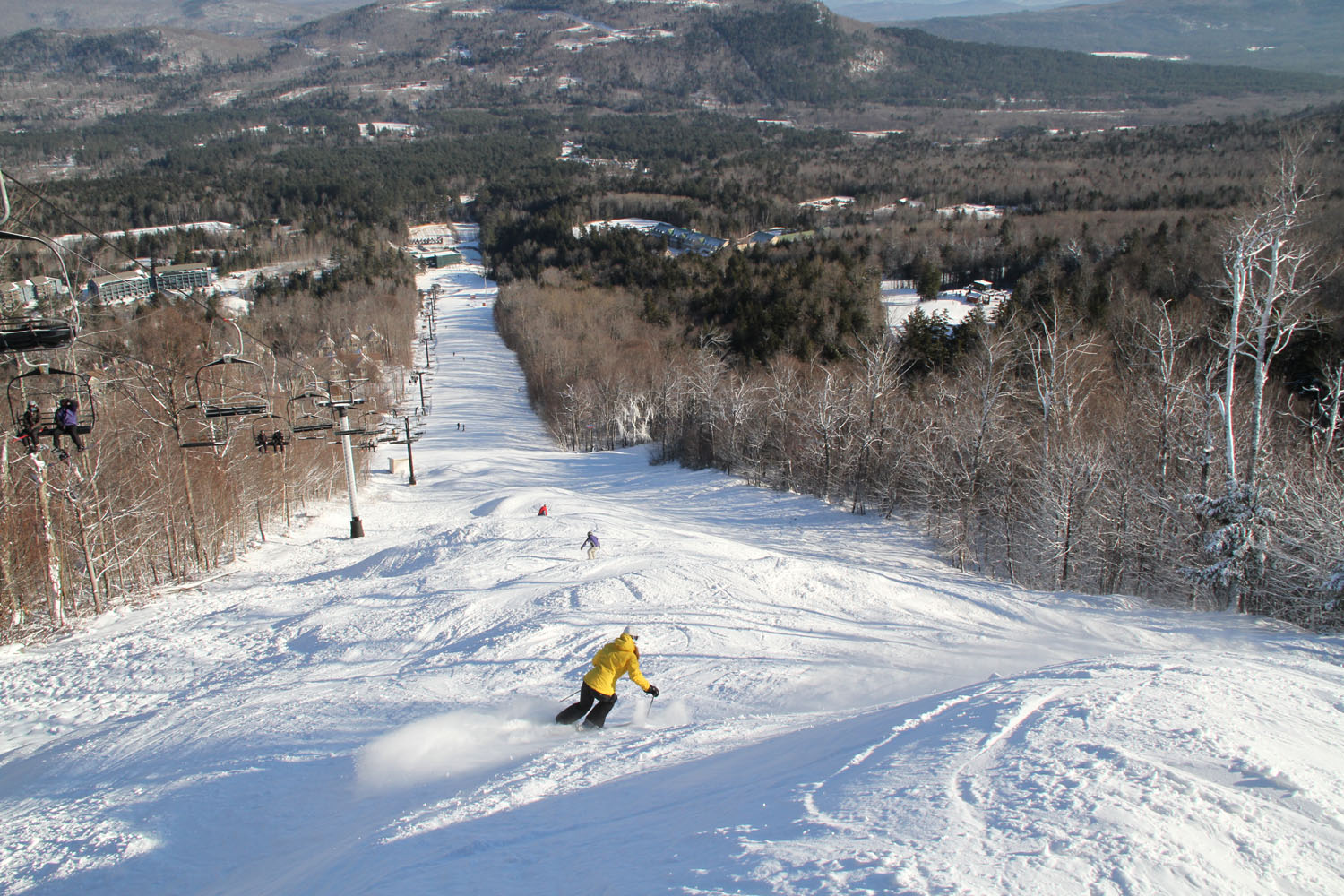 Sunday River in USA - a person riding a snowboard down a hill.