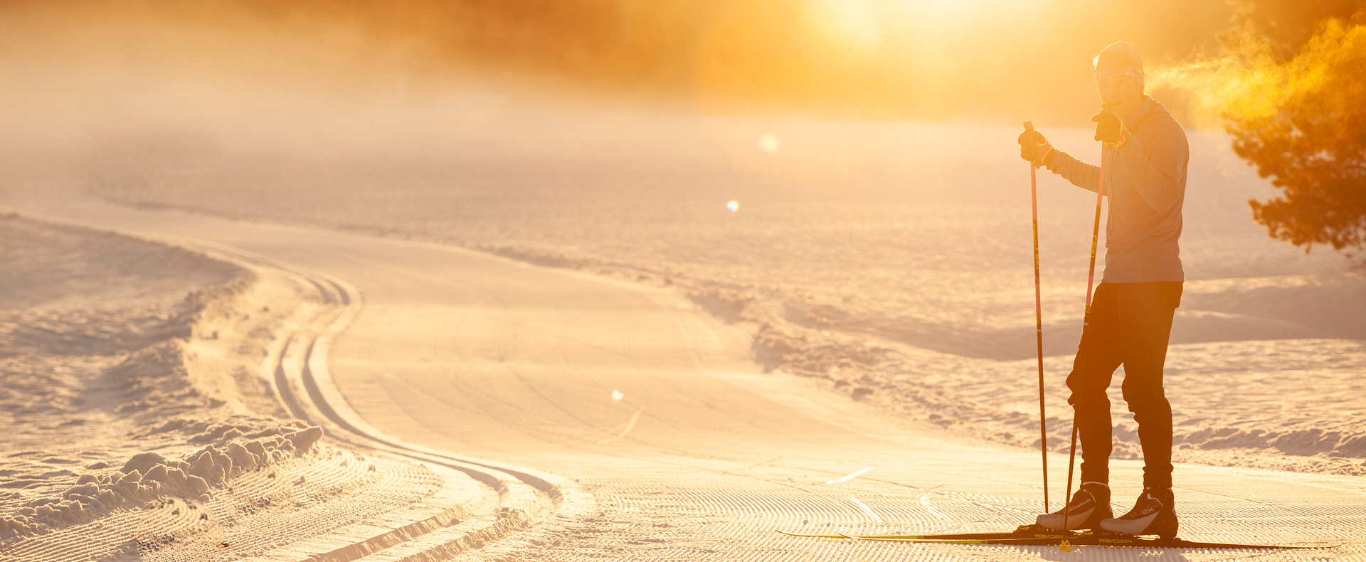 Winter scene at Tahoe Donner in Lake Tahoe, Truckee, California, showing stunning winter scenery with snow-covered ground and trees, depicting a winter sports scene under a bright sunny day with a distant chalet.