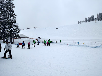 Skiers enjoying the winter sports scene at Tahoe Donner ski resort in Lake Tahoe Truckee California USA.