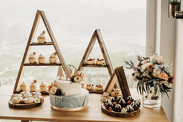 View of the serene Zahmer Kaiser mountain in Tyrol, Austria, with a charming mountain hut and lodge nestled amidst its snowy inclines.