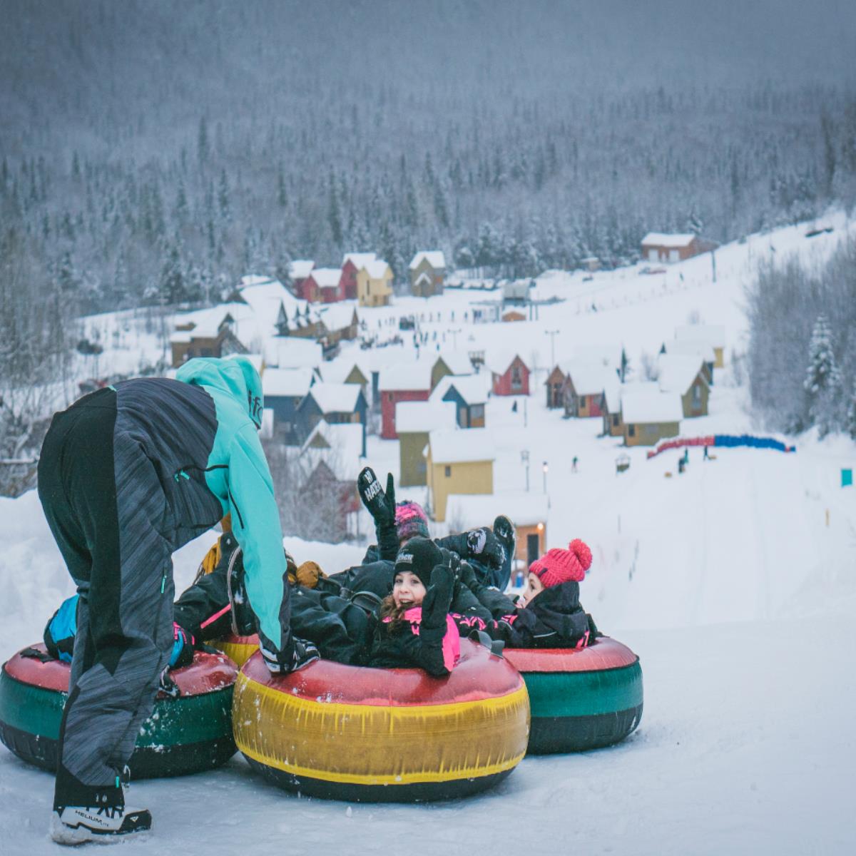 Pin Rouge in Canada - a person on a snow tube in the snow.