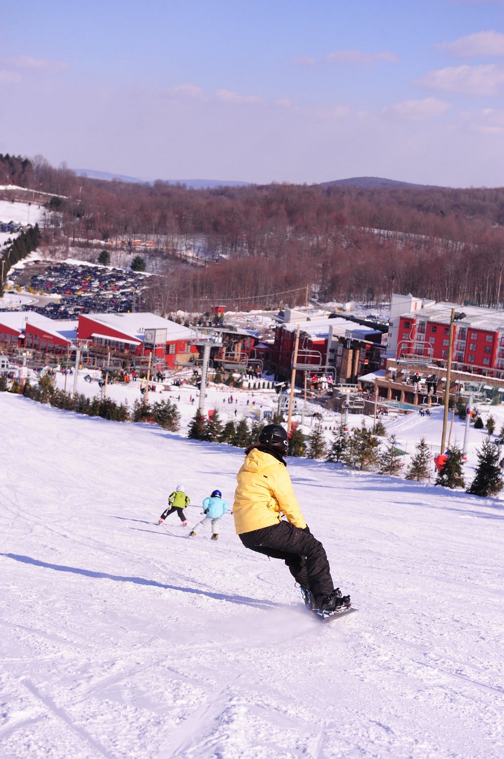 Winter scene at Bear Creek Mountain Resort, Pennsylvania. Skiers enjoy slopes, gliding past a ski lift in this bustling sports center.
