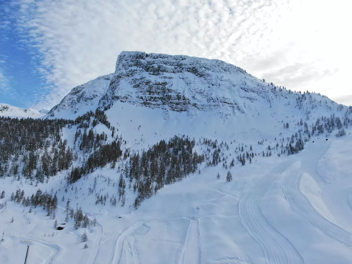Gerlosstein in Austria - a snow covered mountain with ski tracks and trees.