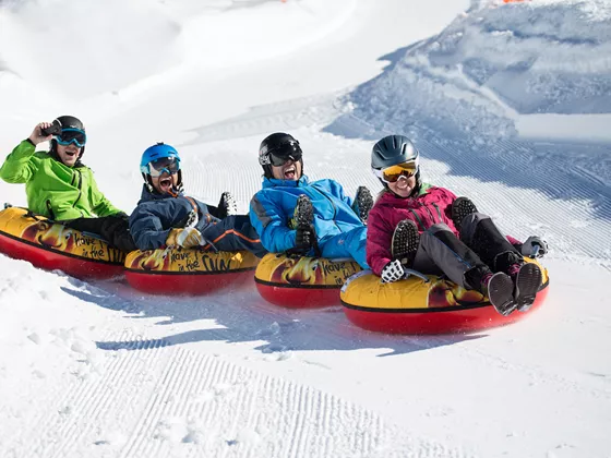 Family enjoying a day of skiing at the Gerlosstein ski resort in Hainzenberg, Tyrol, Austria, presenting a classic winter sports scene amid a snowy landscape.