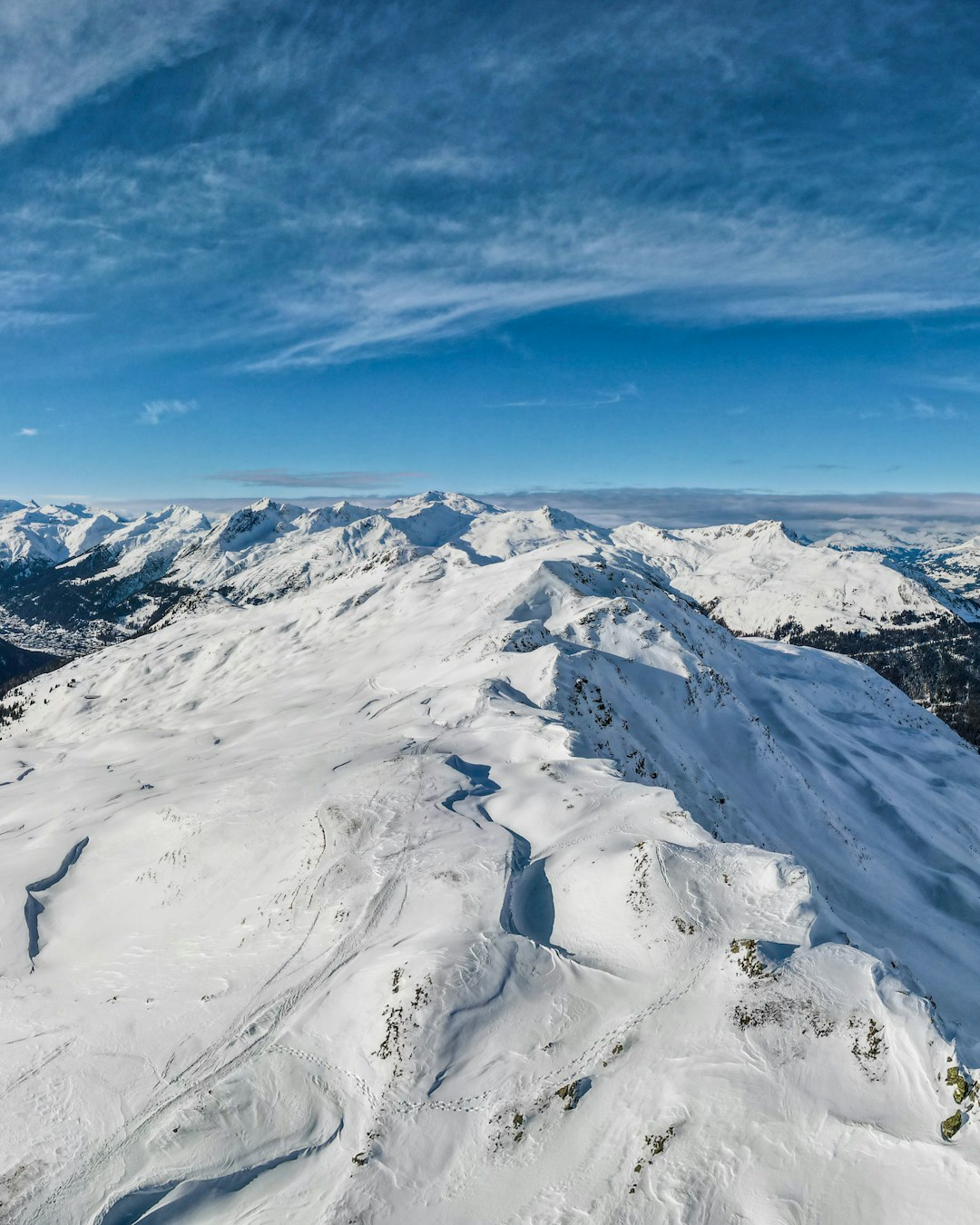 Parsenn in Switzerland - a person on a snowboard on a snowy mountain.