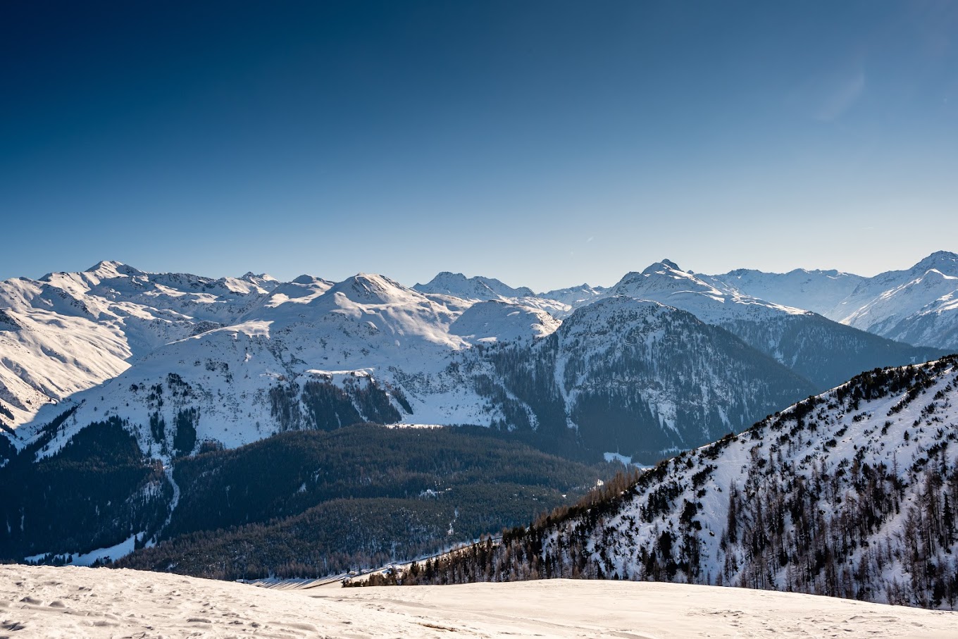 Winter sports scene at Parsenn ski resort in Davos Switzerland showcasing skiers on the mountainside a charming challet in sight surrounded by the breathtaking winter scenery.