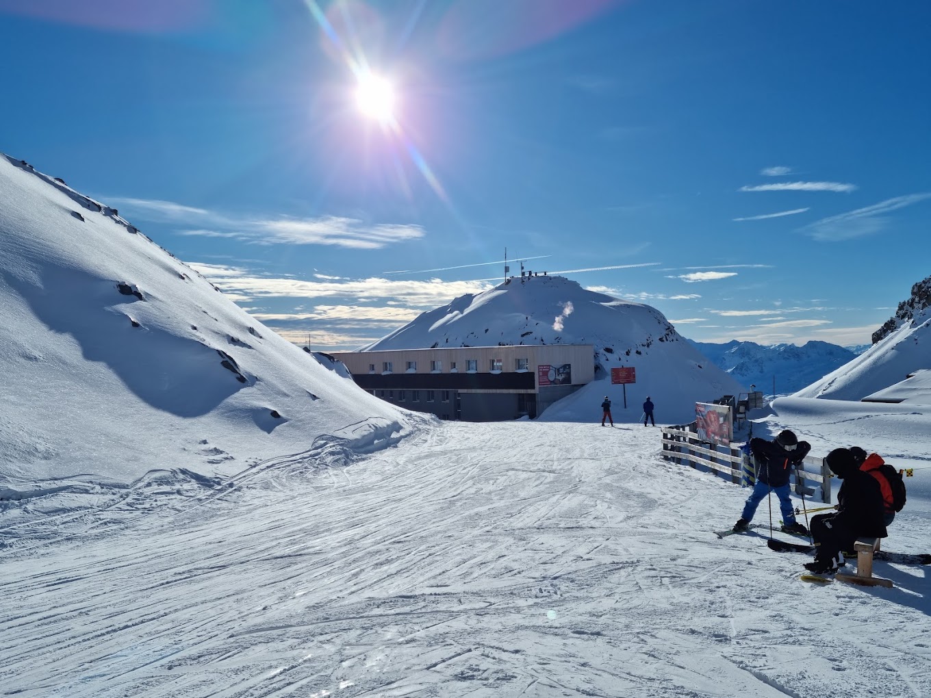 A captivating winter sports scene in Parsenn Davos Switzerland featuring a bustling ski resort a cozy chalet and a quaint mountain hut all ensconced amid pristine snow-covered slopes.