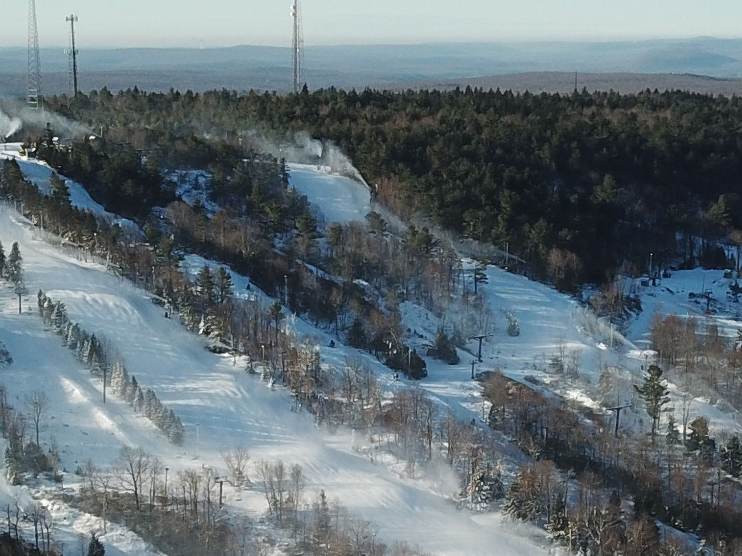 Jack Frost Mountain in USA - a ski slope covered in snow with trees in the background.