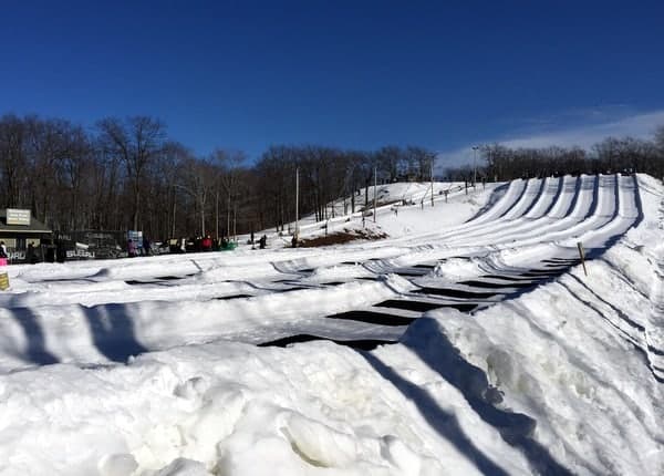 Winter sports enthusiasts enjoying a day at the bustling Jack Frost Mountain in White Haven, Pennsylvania. The snow-covered slopes of the ski resort provide a beautiful winter backdrop.