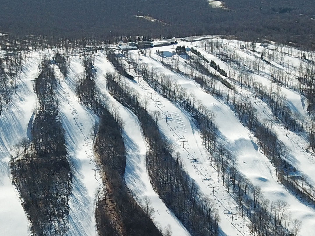 Jack Frost Mountain in USA - an aerial view of a ski slope with snow on the ground.