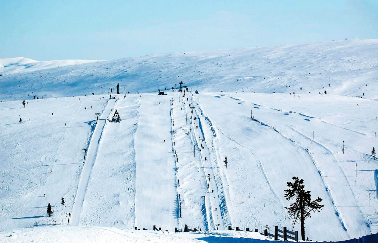 Saariselkä in Finland - a ski slope with people skiing down it.