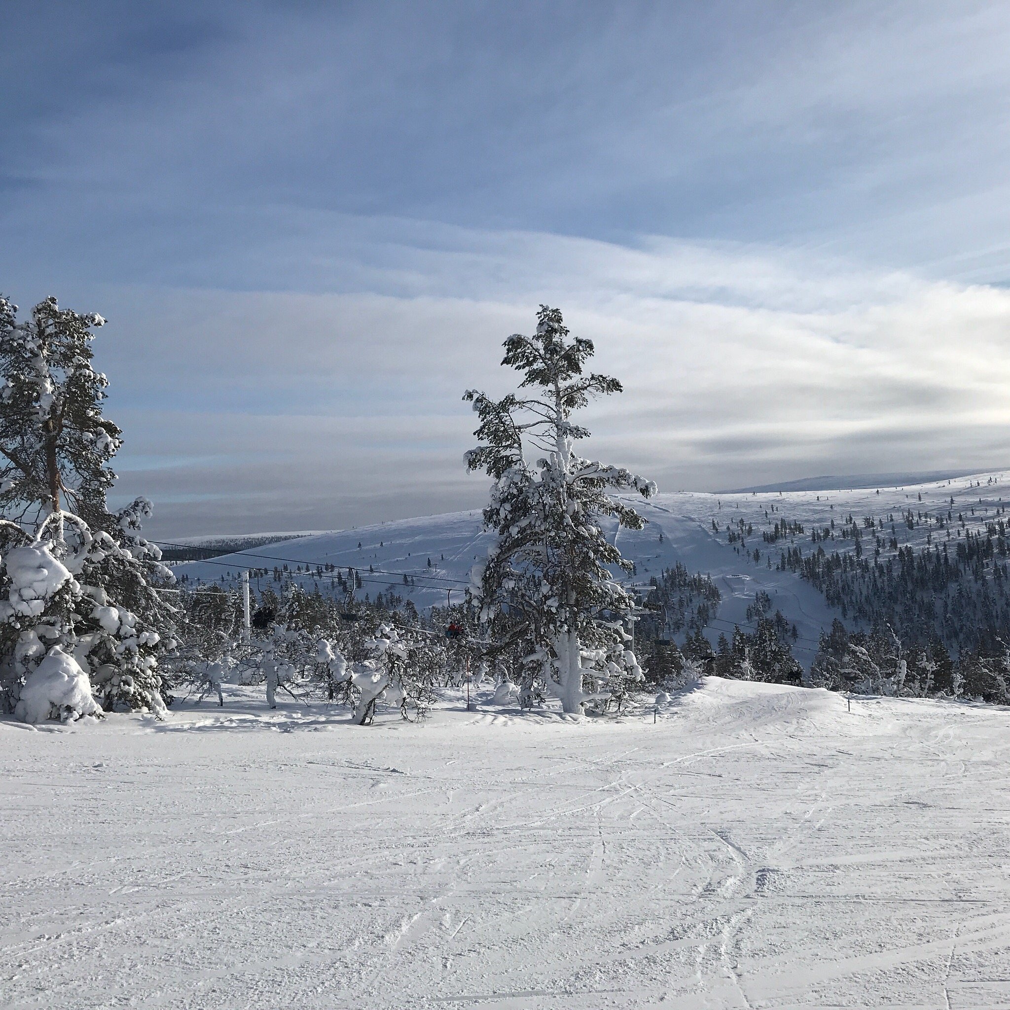 Winter scene in Saariselkä, Lapland, featuring a skier at a ski resort amidst stunning snowy scenery, characteristic of Northern Finland. A picturesque winter sports scene.