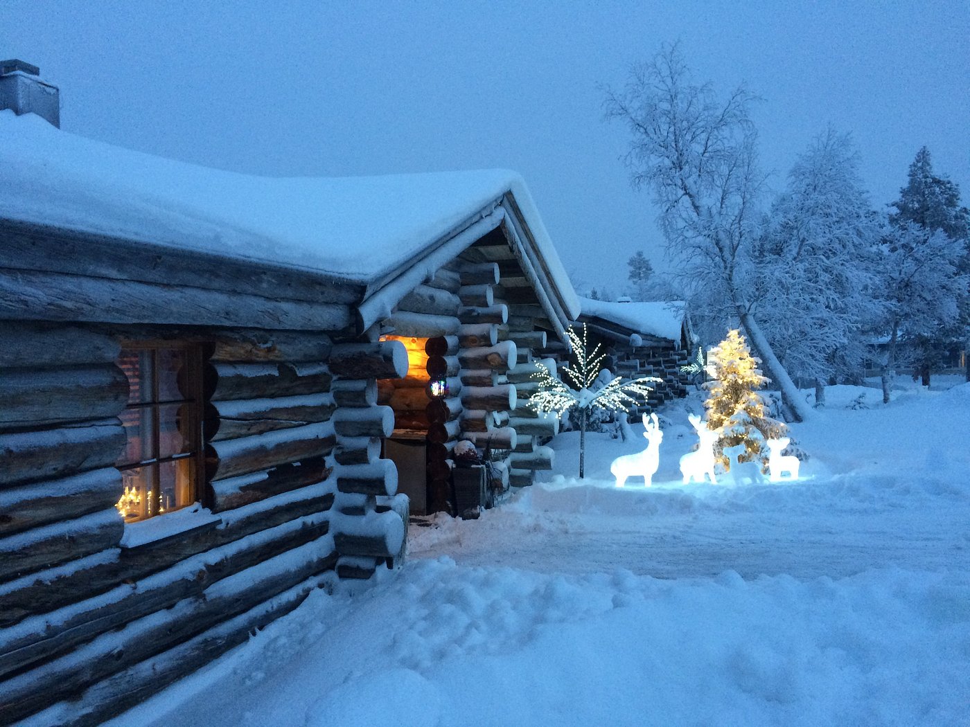 Striking winter scene in Saariselkä, Lapland, Northern Finland showcasing the mesmerizing beauty of Nordic winters. A charming lodge and winter sports centre add vibrancy to the icy landscape.