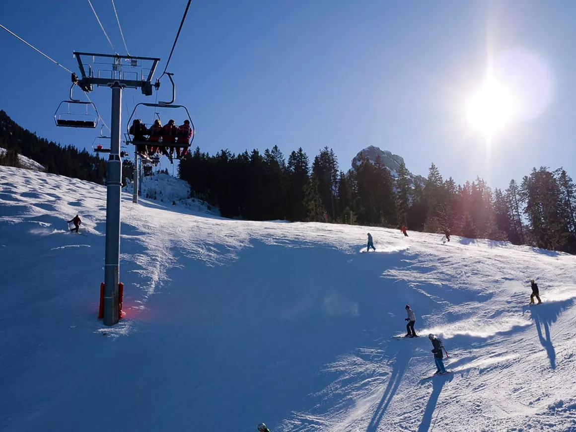 La Sambuy-Seythenex in France - a group of people riding down a snow covered slope.
