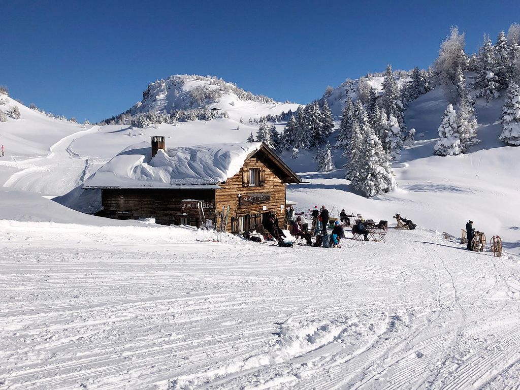 Feldis in Switzerland - a group of people standing on top of a snow covered mountain.