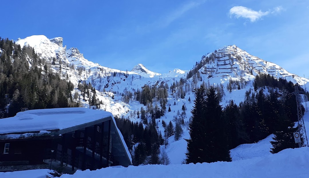 Winter scene at Pescegallo Valgerola Ski Resort, Valtellina, Italy, showcasing stunning winter scenery, sports activity on the mountains, under the clear sky.