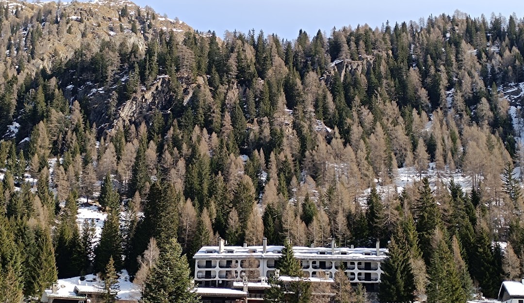 Scenic view of Pescegallo Valgerola a ski resort in Lombardy Italy featuring a chalet a mountain and a ski lift amidst a winter sports setting.