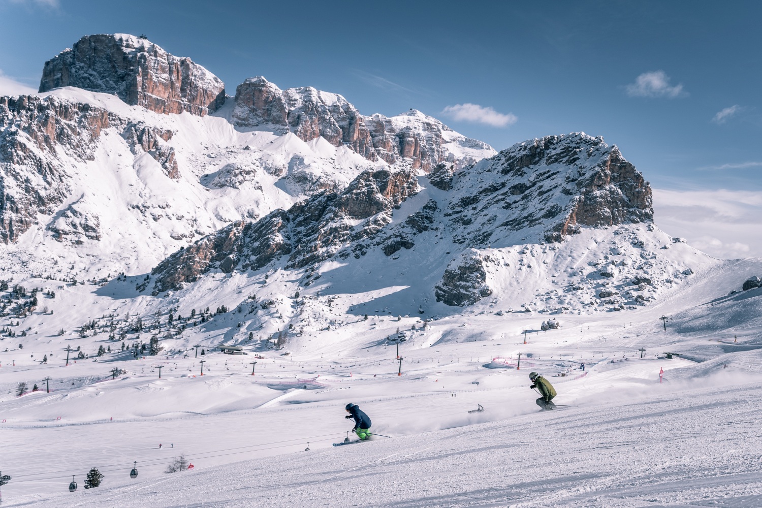 Val di Fassa ski in Italy - a group of people skiing down a snow covered mountain.
