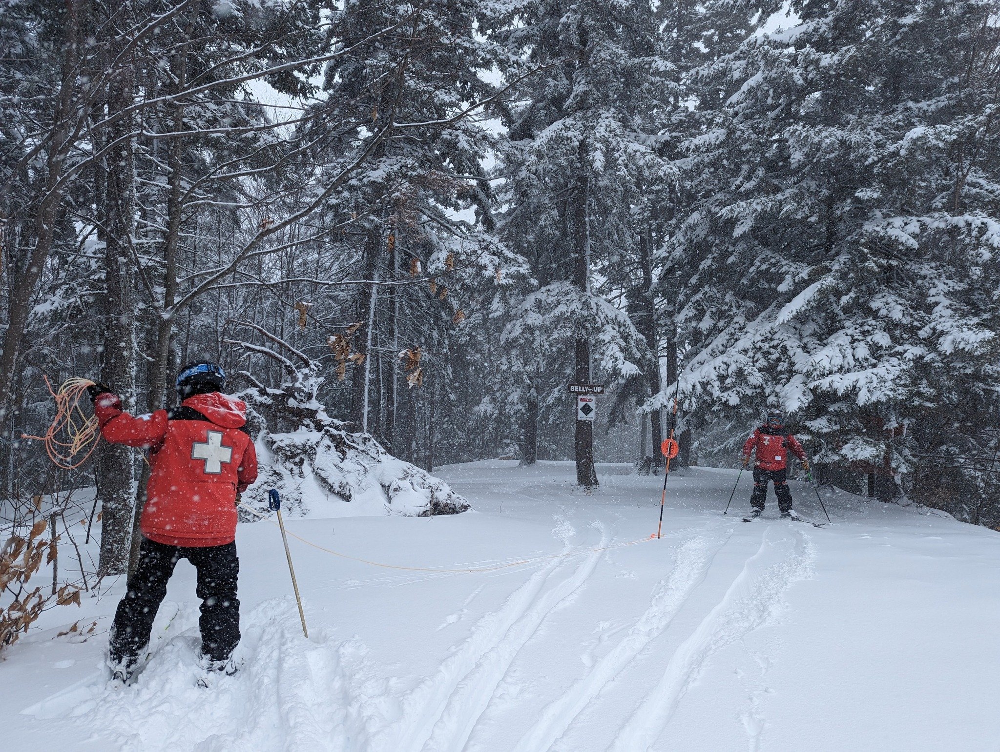 A vibrant winter sports scene at Whaleback Enfield New Hampshire showcasing a challet in the backdrop with families skiing amid a well-equipped winter sports centre.