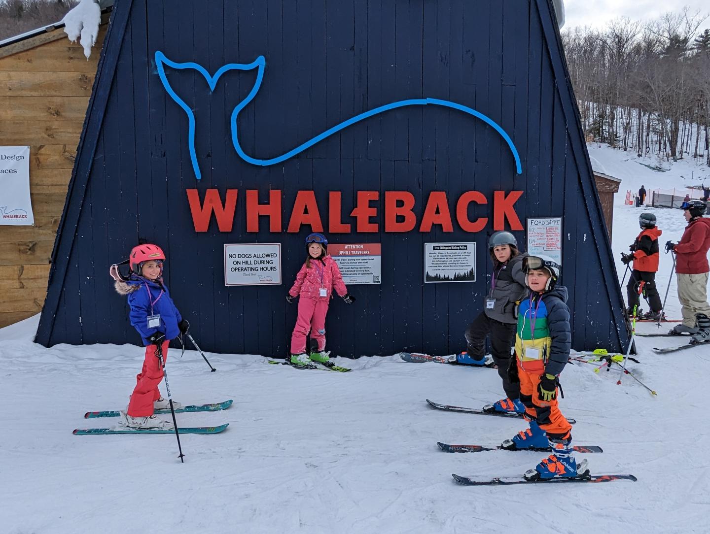 Whaleback in USA - a group of kids standing in front of a whale sign.