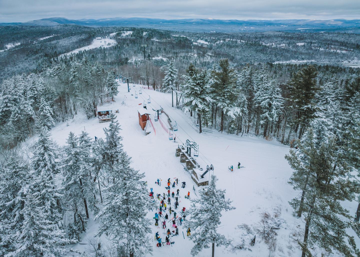 Whaleback in USA - a group of people skiing down a hill in the winter.