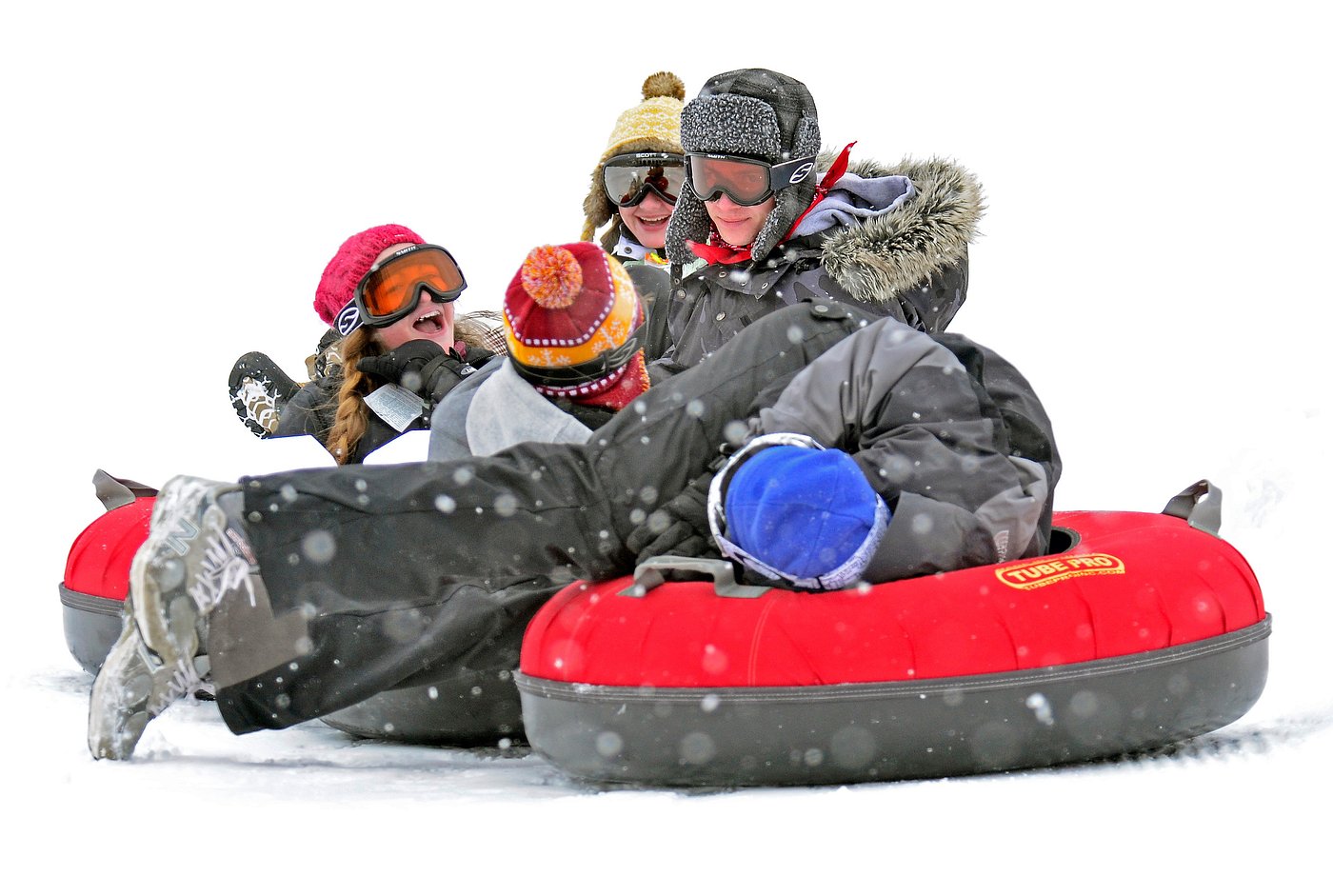 A lively winter sports scene at Canaan Valley West Virginia featuring a snowmobile in the foreground and a chalet and sports center in the background with a family skiing nearby.