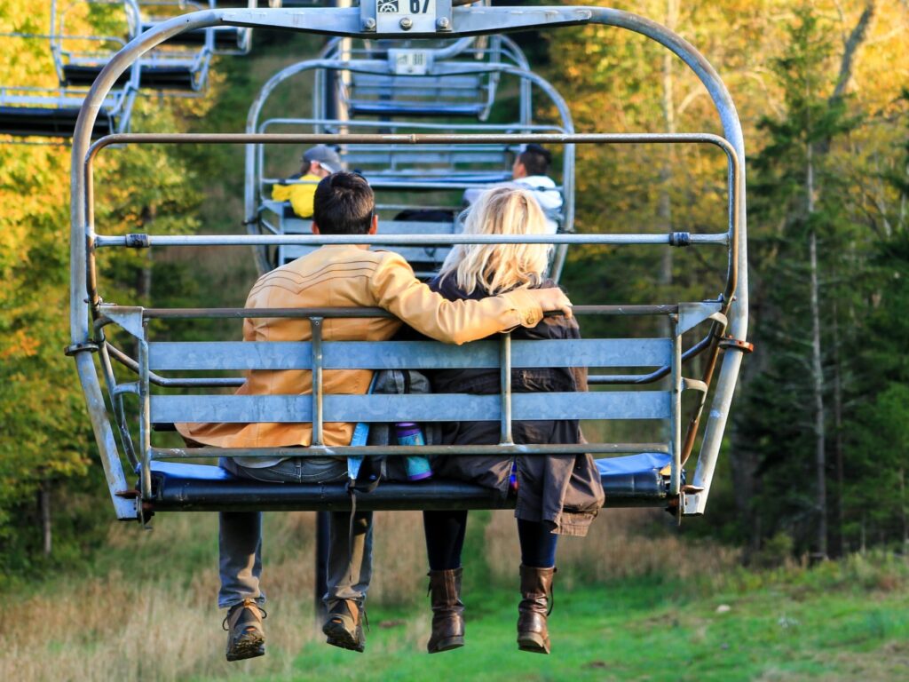 Canaan Valley in USA - two people sitting on a ski lift in the woods.