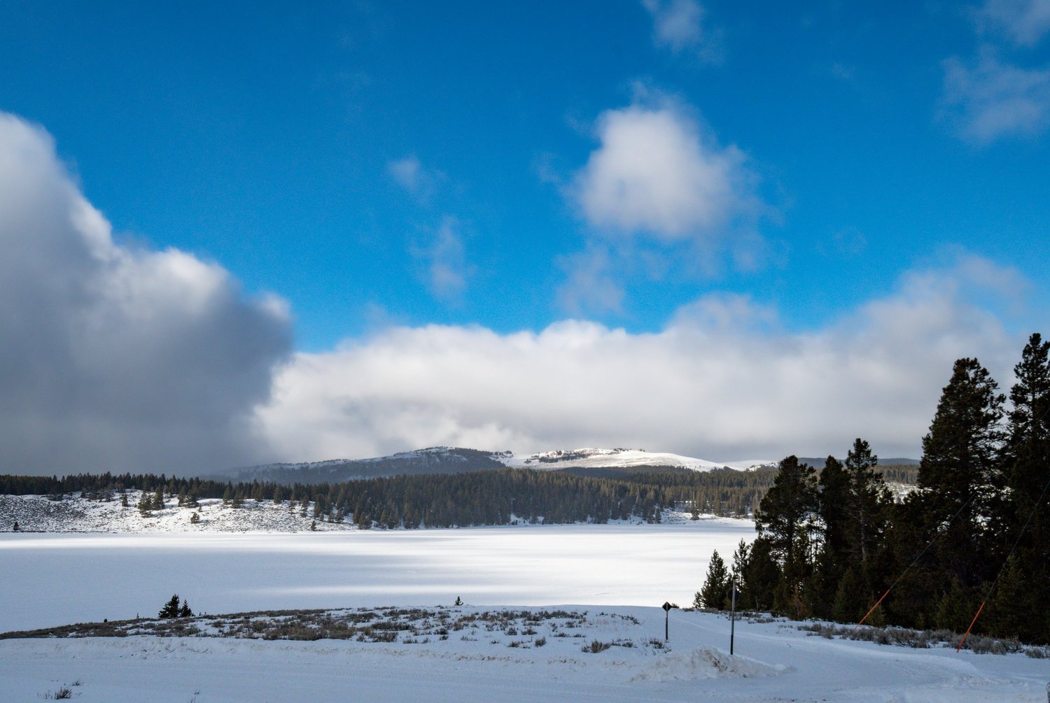 A picturesque winter scene at Meadowlark Ski Lodge in Ten Sleep Wyoming capturing a wintry sports activity amidst a stunning snow-covered mountain backdrop.