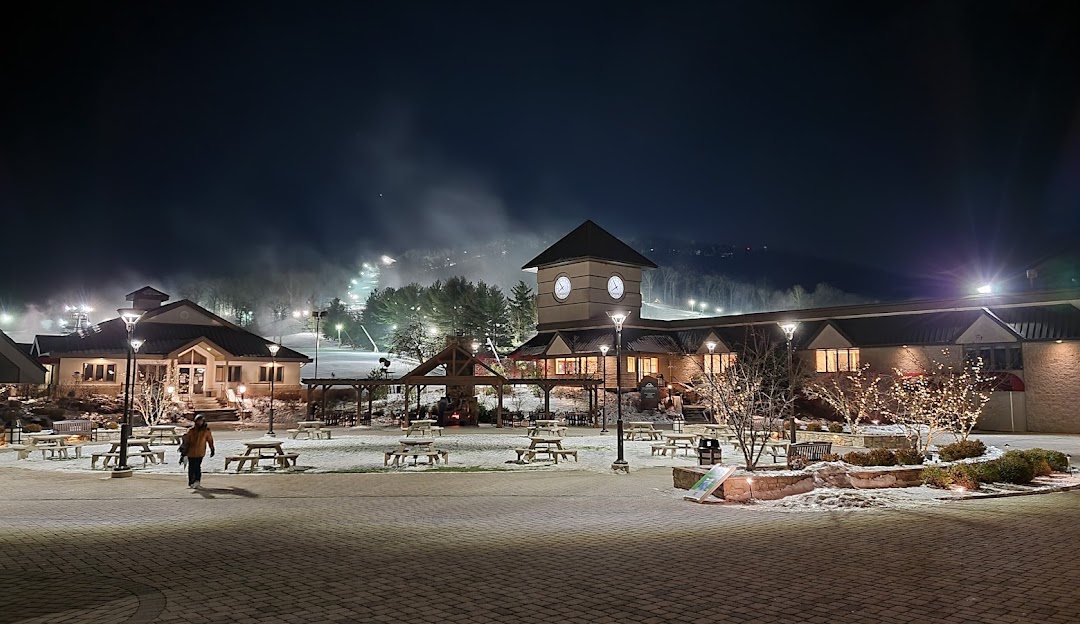 View of Liberty Mountain ski resort in Fairfield Pennsylvania showcasing a picturesque winter landscape abundant ski slopes and a cozy lodge in the distance.