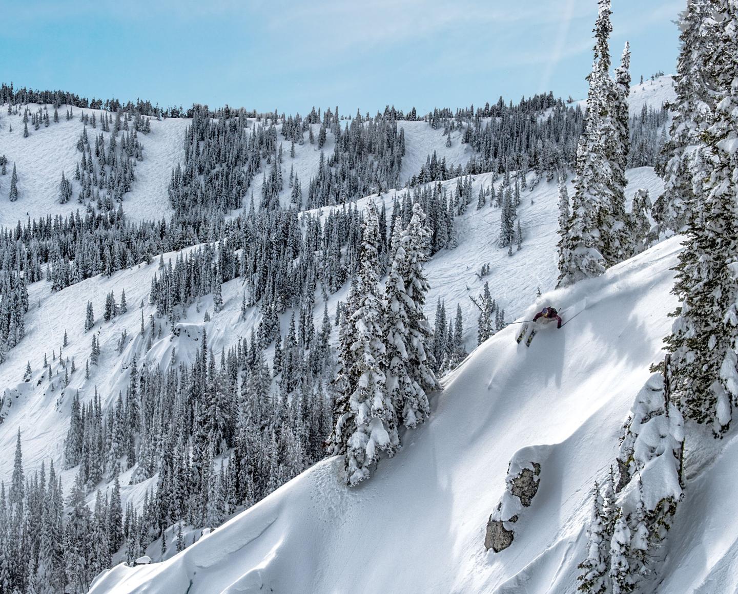 Nayoro Piyashiri in Japan - a man riding a snowboard down a snow covered mountain.