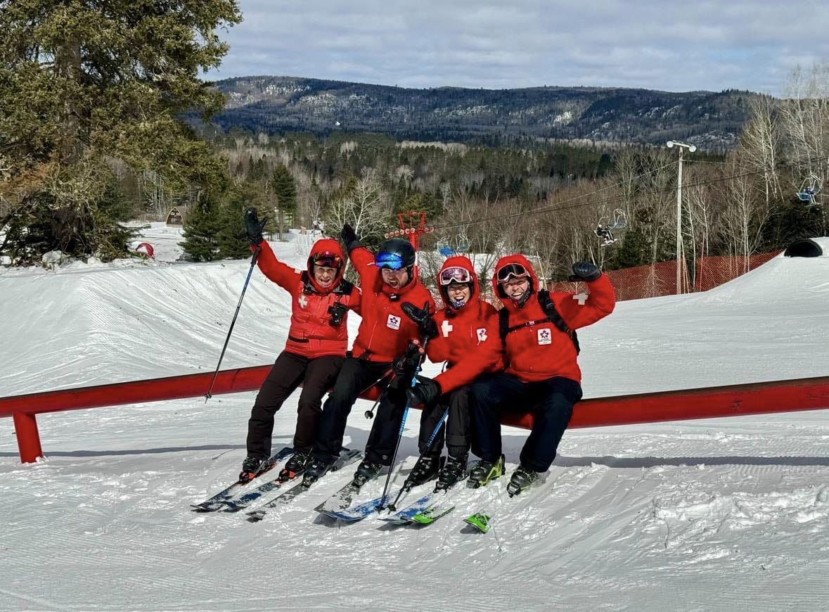 Searchmont in Canada - a group of people on skis posing for a picture.