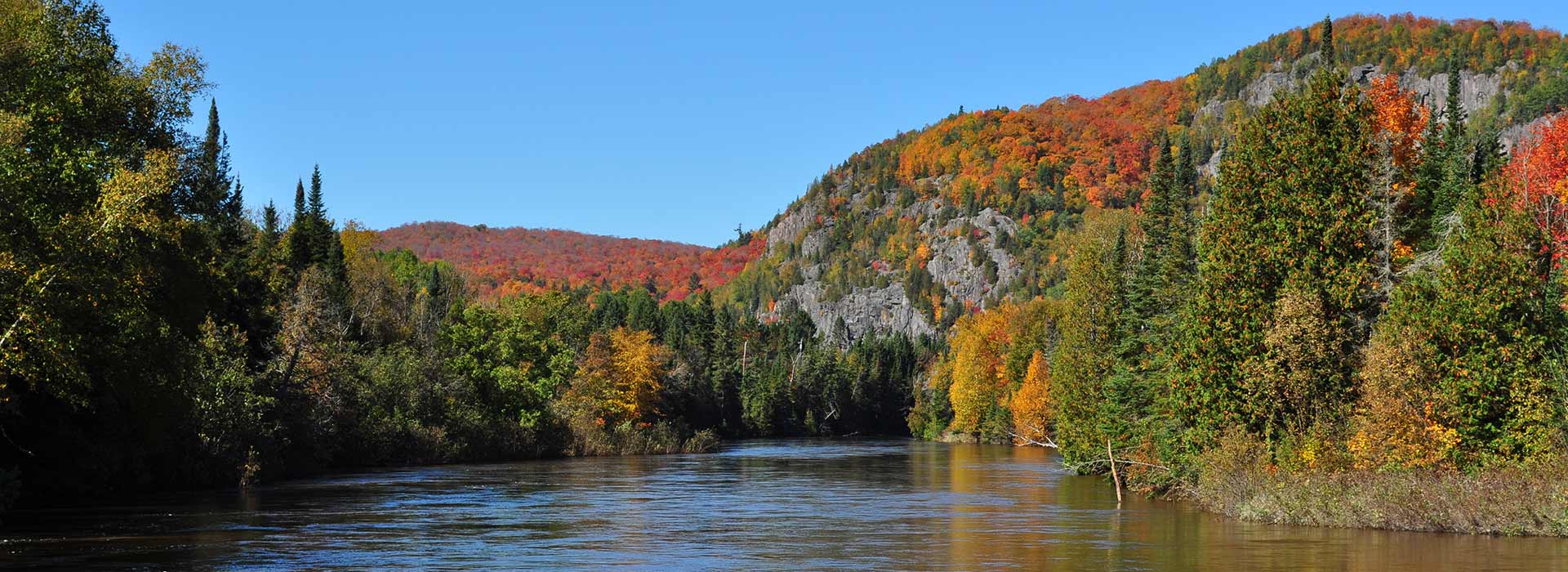 Searchmont in Canada - a river surrounded by trees in the fall.