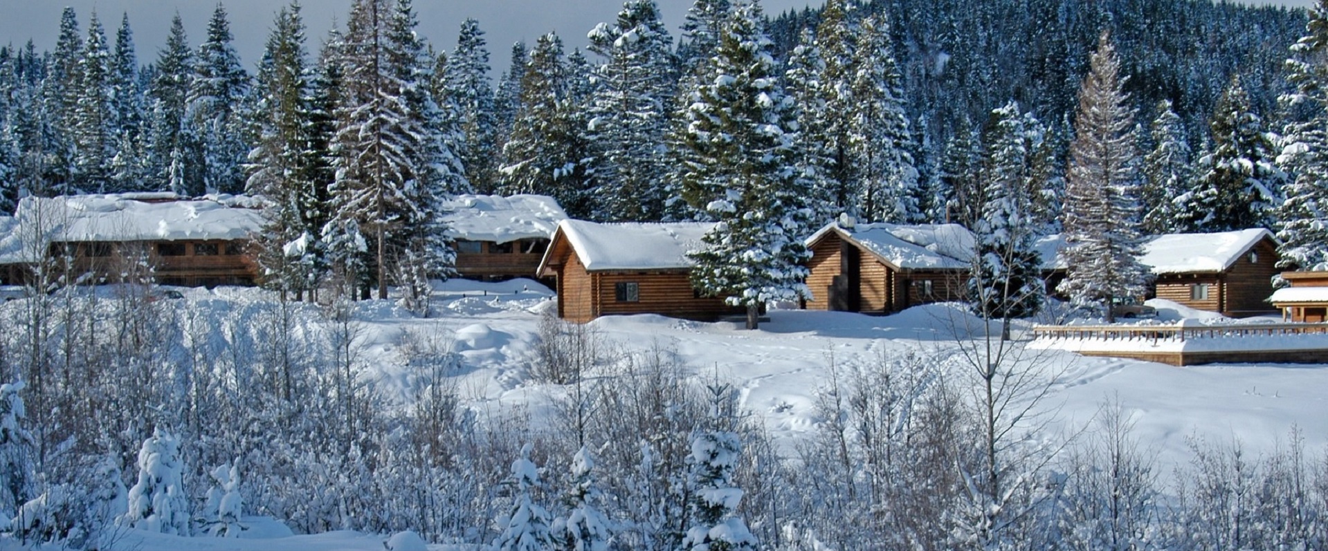 Cooper Spur in USA - a group of cabins in the woods covered in snow.
