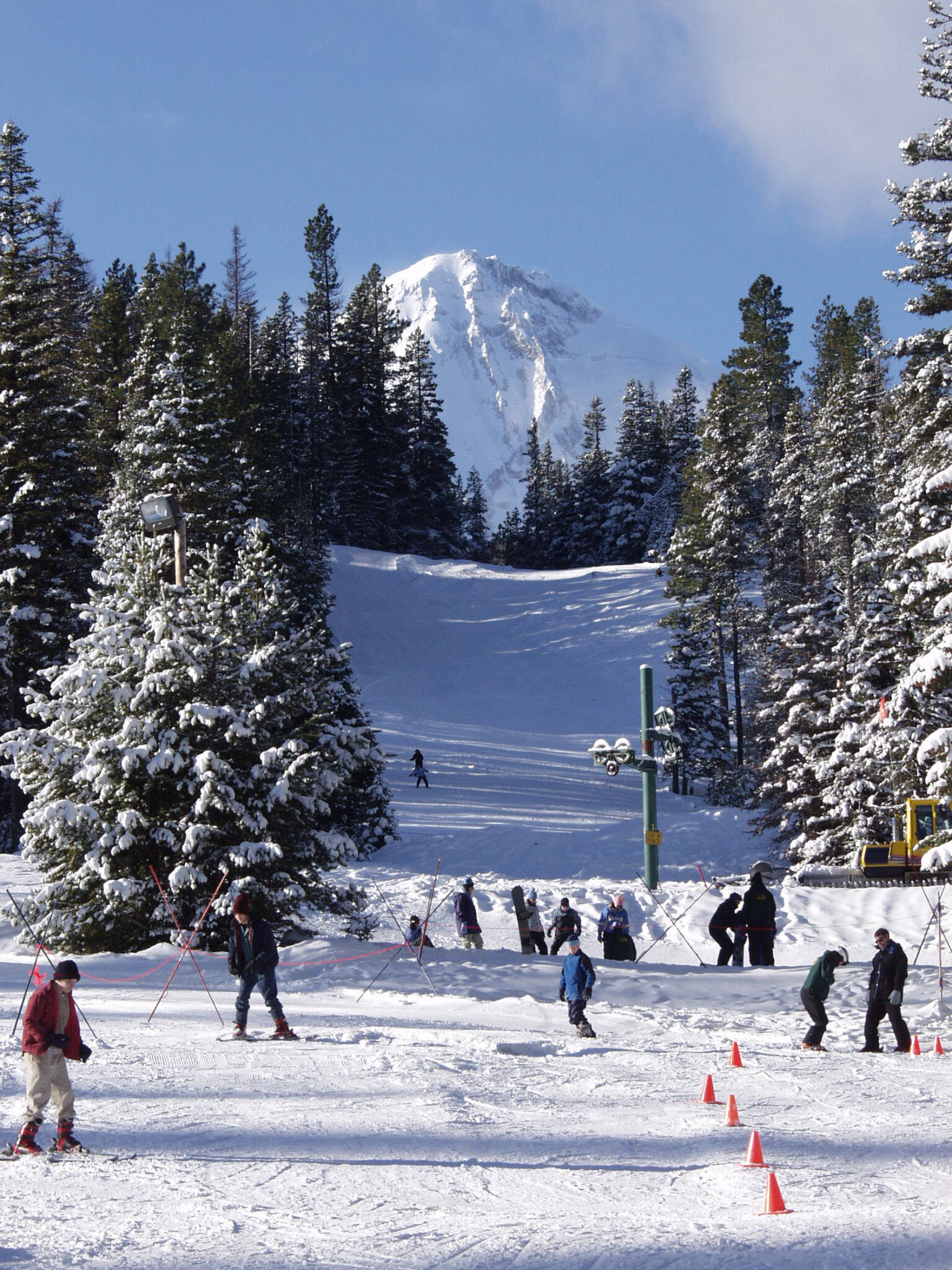 Cooper Spur in USA - a group of people skiing down a snowy slope.