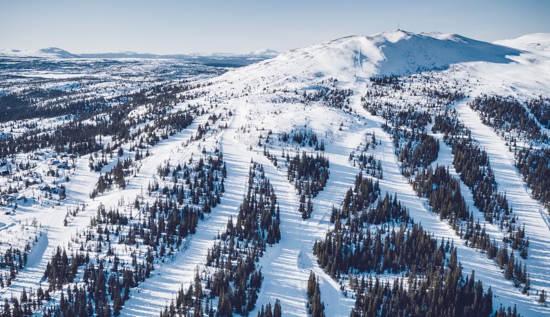 Ski resort in Bydalsfjällen, Northern Sweden featuring snow-covered slopes, a ski lift, and skiers enjoying winter sports.
