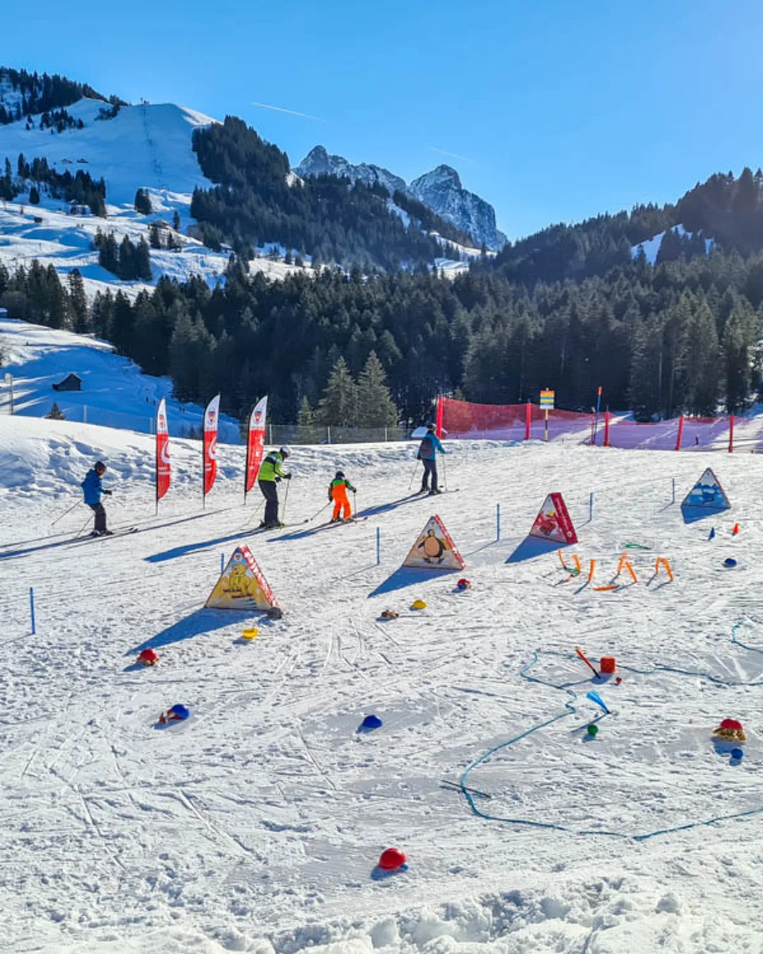 Sattel-Hochstuckli in Switzerland - a group of people skiing down a snow covered slope.